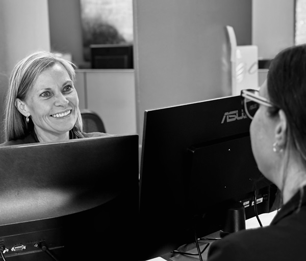 Dr. Alm explaining the treatment to his patient sitting in the dentist's chair